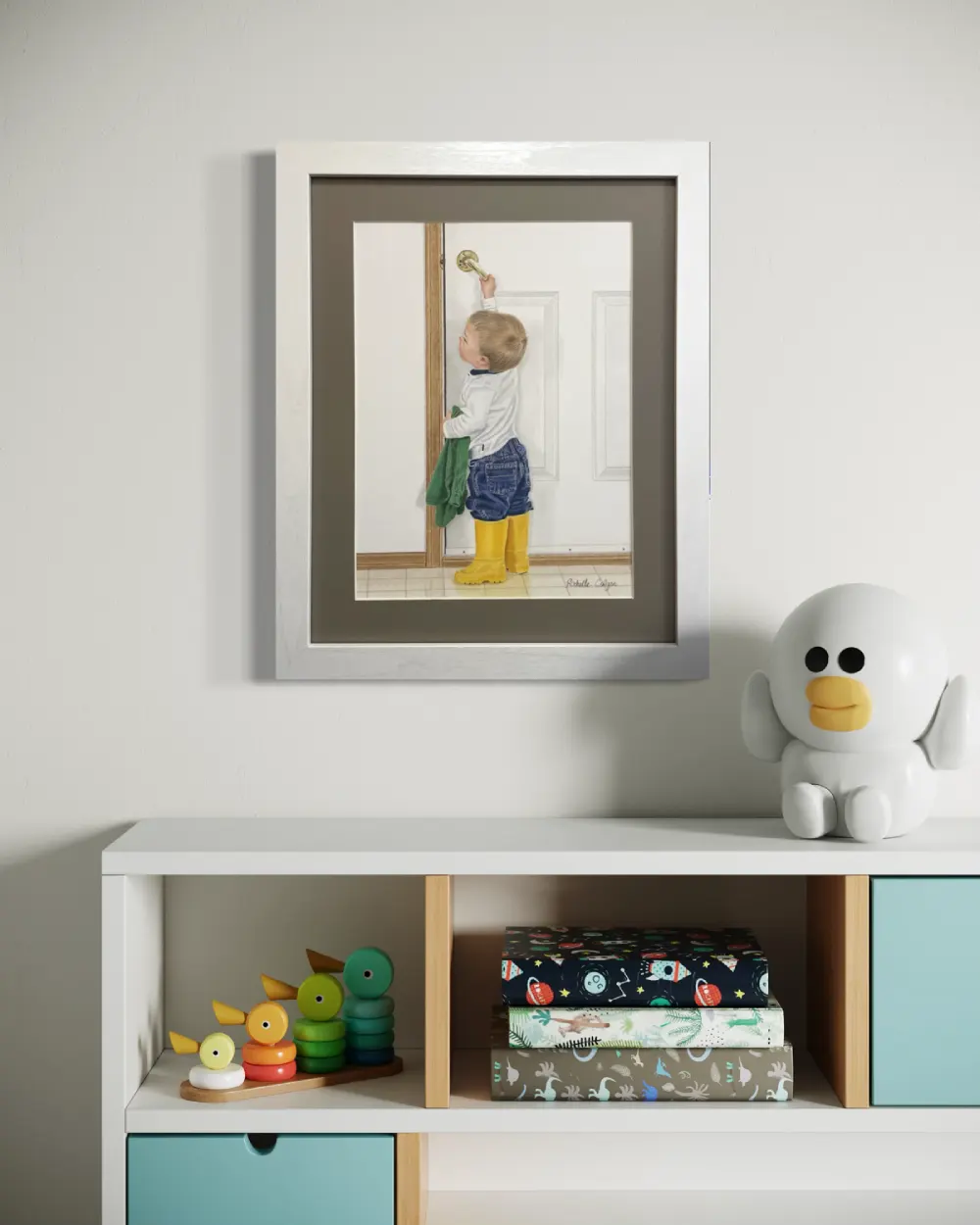 Framed realistic drawing of a 2 year old boy with bright yellow rubber boots pulling down the handle to open a door to the outside, hanging on a wall. By Alberta artist Rochelle Colgan