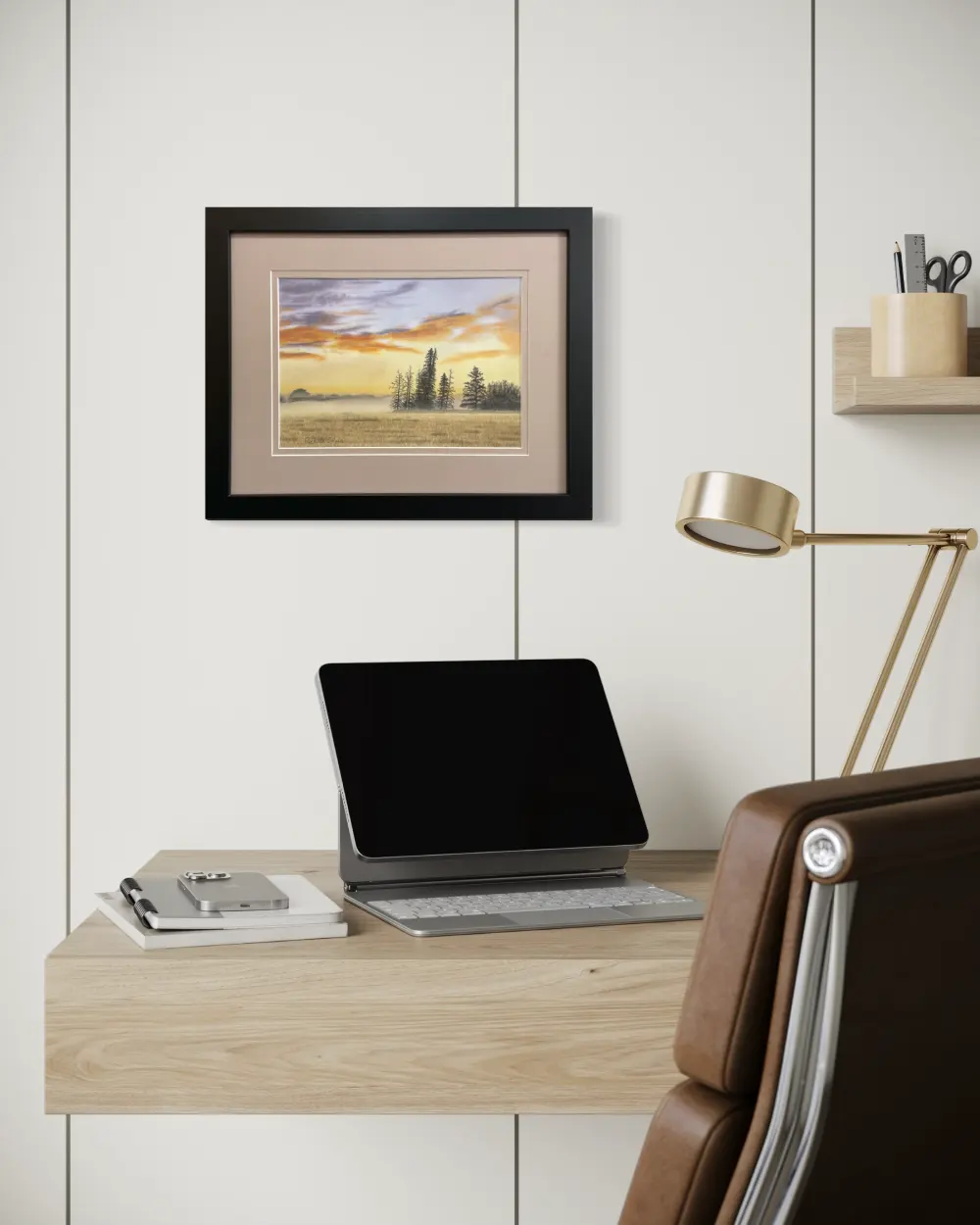 Framed realistic sunrise skyscape drawing with purple and orange clouds, light orange sky along the horizon with distant trees and mist, hanging on a wall. By Alberta artist Rochelle Colgan